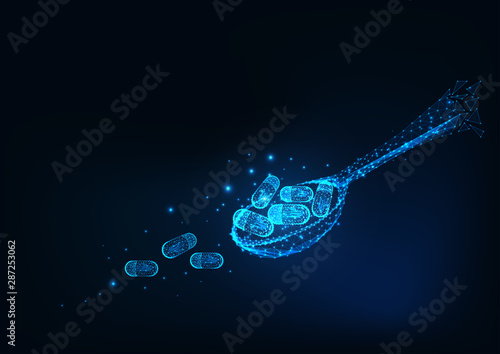 Futuristic glowing low polygonal spoon with medicine pills isolated on dark blue background. © Inna