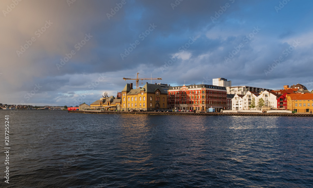 Stavanger, Norway - July 2019: The harbour in Stavanger city. This area is called Vågen. Evening with the rainbow