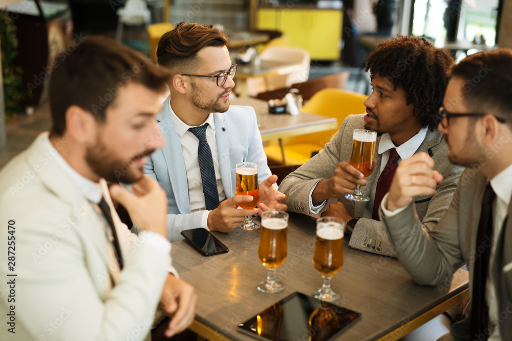 young businessmen after work in a pub young businessmen after work in a pub