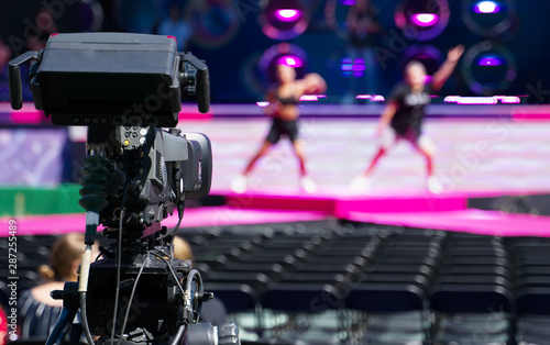 Professional video camera is filming live performance.