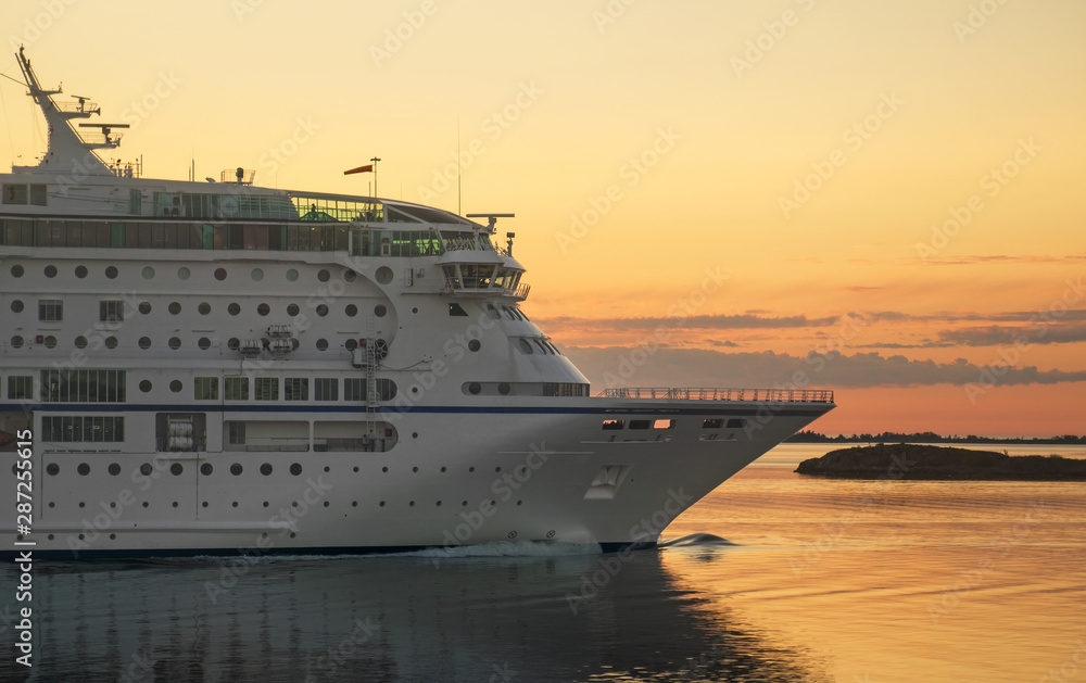 Passenger ferry against a sunset in the Baltic sea. - obrazy, fototapety, plakaty 