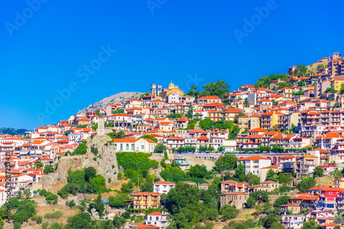 Fototapeta Naklejka Na Ścianę i Meble -  Scenic view of Arachova Village. Arachova is famous for its panoramic view, uphill small houses and the cobbled streets show a picturesque architecture at Parnassos Mountain,  Greece.
