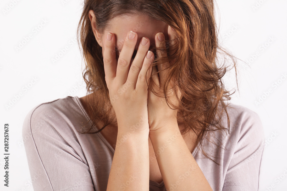 Portrait of depressed woman, covering face with her hands Portrait of depressed woman, covering face with her hands