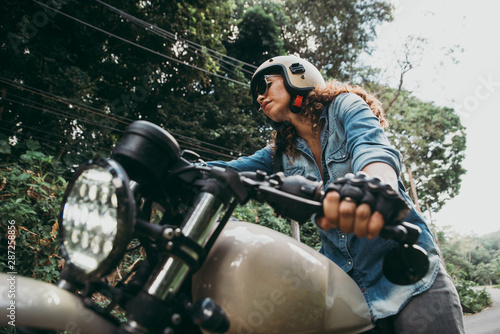 beautiful woman making a jungle tour with her motorcycle