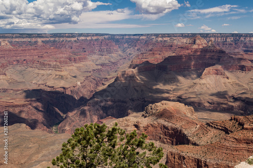 Cloud shadows drifting across rocky ravines in the Grand Canyon