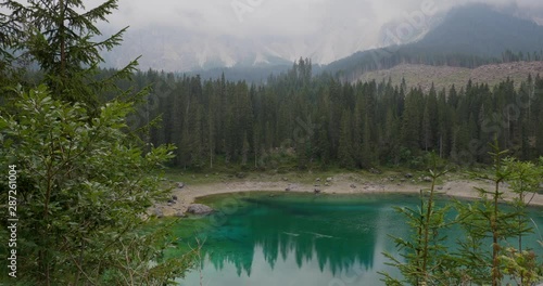 Lake Karezza, mountain lake famous. Reflection of the Rose Garden Mountain in the Lake. In 2018, a massive storm destroyed all the trees in the area. South Tirol, Italy  photo