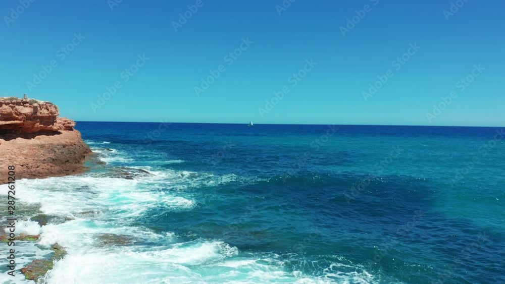 Aerial view. Beautiful sailboat on background blue ocean on a bright sunny day. Aerial view. Beautiful sailboat on background blue ocean on a bright sunny day.