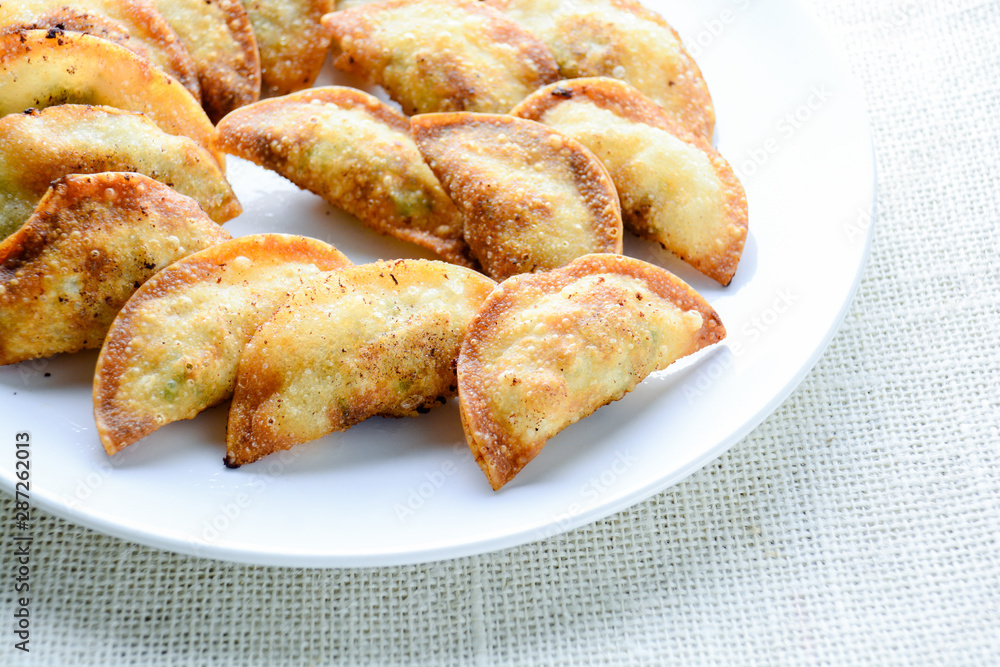 Japanese Fried Dumplings, the half moon-shaped dumplings served in Asian restaurants as an appetiser or side dish, pork and vegetable filling. Japanese Fried Dumplings, the half moon-shaped dumplings served in Asian restaurants as an appetiser or side dish, pork and vegetable filling.