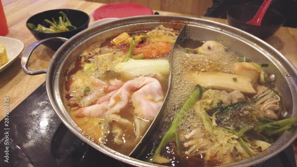 Dipping sliced pork and vegetables in shabu hot pot, Shabu shabu or Sukiyaki, Japanese Food hot boiling Dipping sliced pork and vegetables in shabu hot pot, Shabu shabu or Sukiyaki, Japanese Food hot boiling