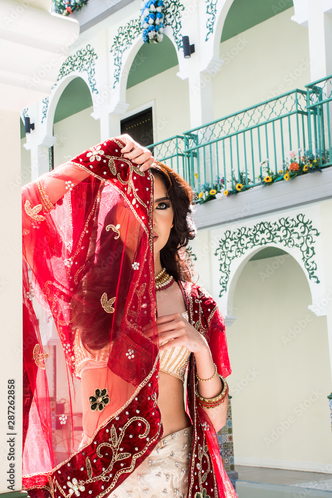 Red Indian Costume Beautiful Girl, face partially covered with saree.  Portrait of Traditional woman in sari dress. foto de Stock | Adobe Stock