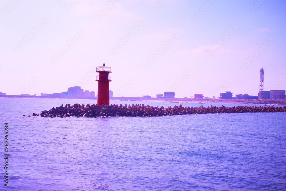 The red lighthouse in the middle of the sea
