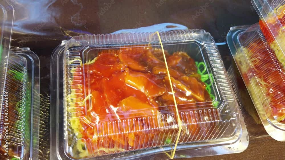 egg noodle soup with BBQ pork in Take away plastic box at night street food market egg noodle soup with BBQ pork in Take away plastic box at night street food market