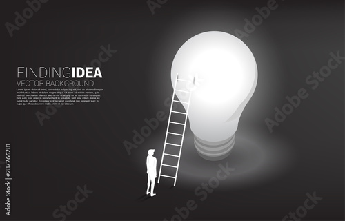 Silhouette of businessman standing with ladder on light bulb . Business Concept of creative idea and solution.