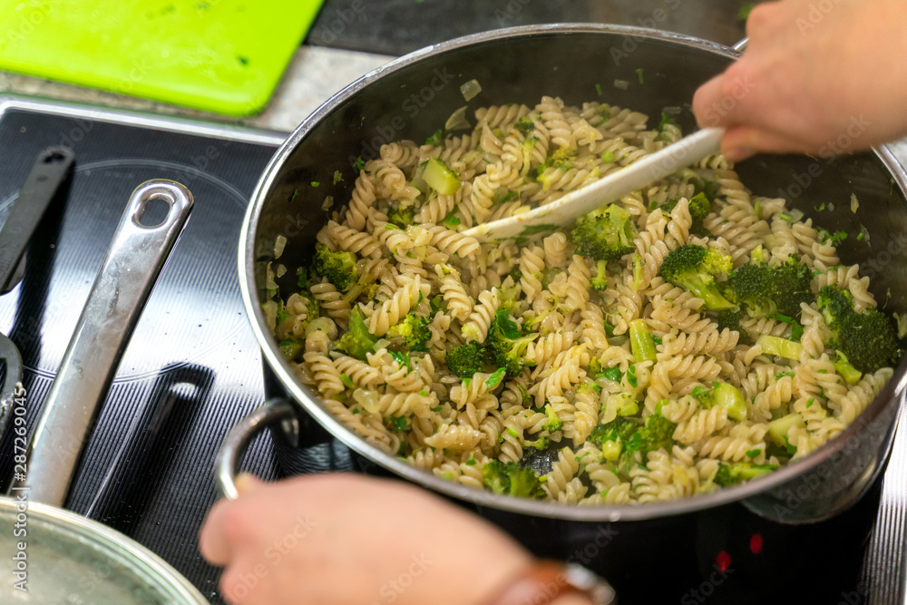 Pasta and broccoli are fried in a pan Pasta and broccoli are fried in a pan