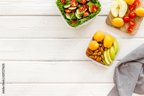 Food container with healthy food on white wooden background top view