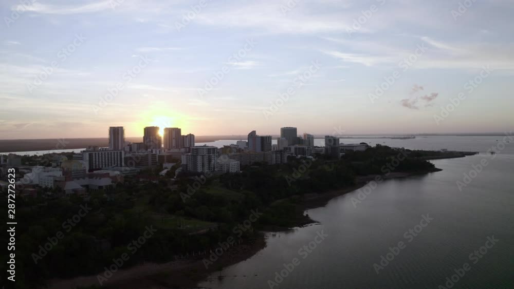 Aerial: Sunset Behind Buildings on a Peninsula in Front of the Ocean in Darwin Aerial: Sunset Behind Buildings on a Peninsula in Front of the Ocean in Darwin