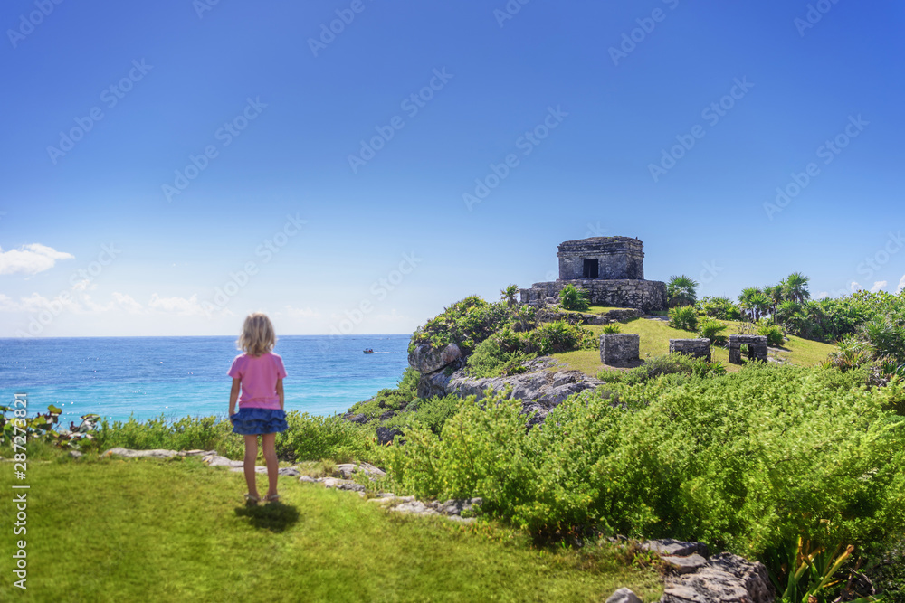 Girl looking at the ruins of Tulum.