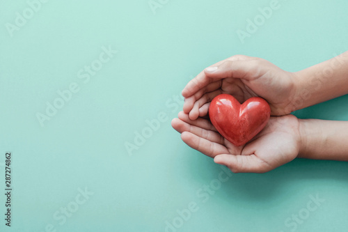 hands holding red heart, health care, love, organ donation, wellbeing family insurance,CSR concept, world heart day, world health day, hope, gratitude,  praying concept photo