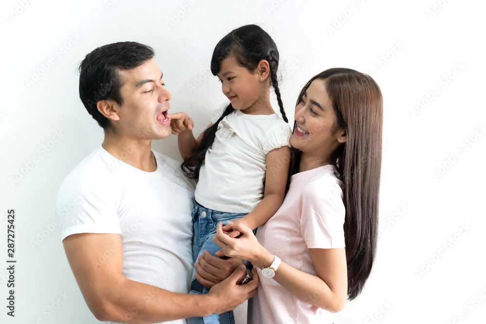Fototapeta premium Portrait of happy family father and mother with daughter on white background