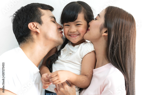 Portrait of happy family father and mother with daughter on white background