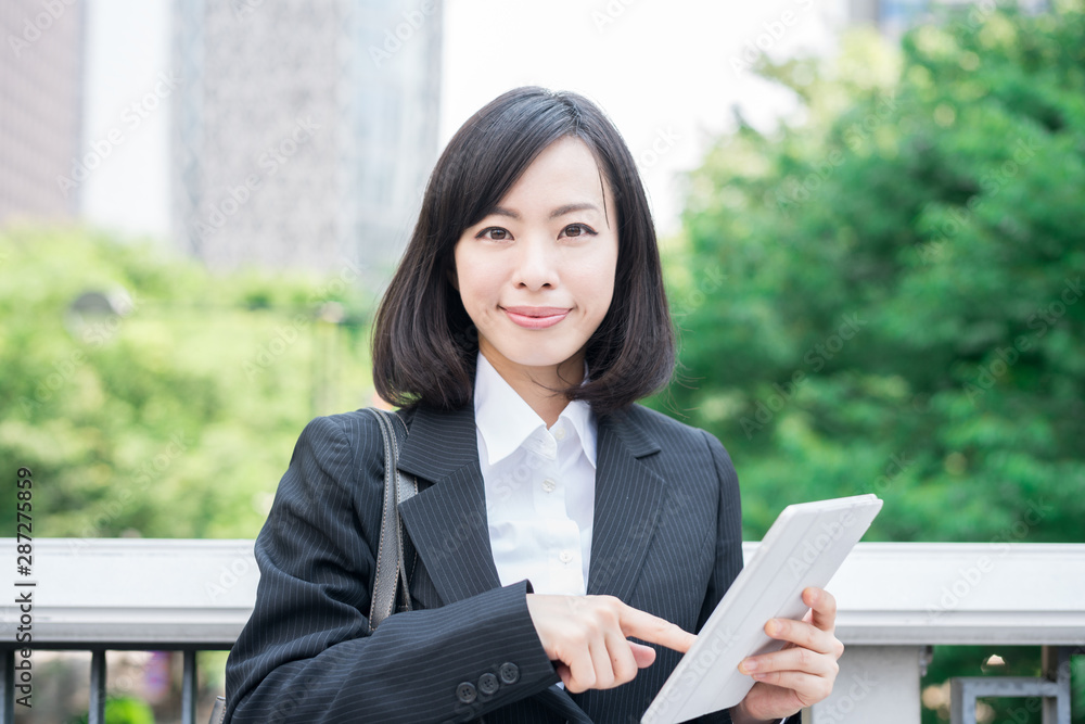 Young business woman using tablet computer outside Young business woman using tablet computer outside