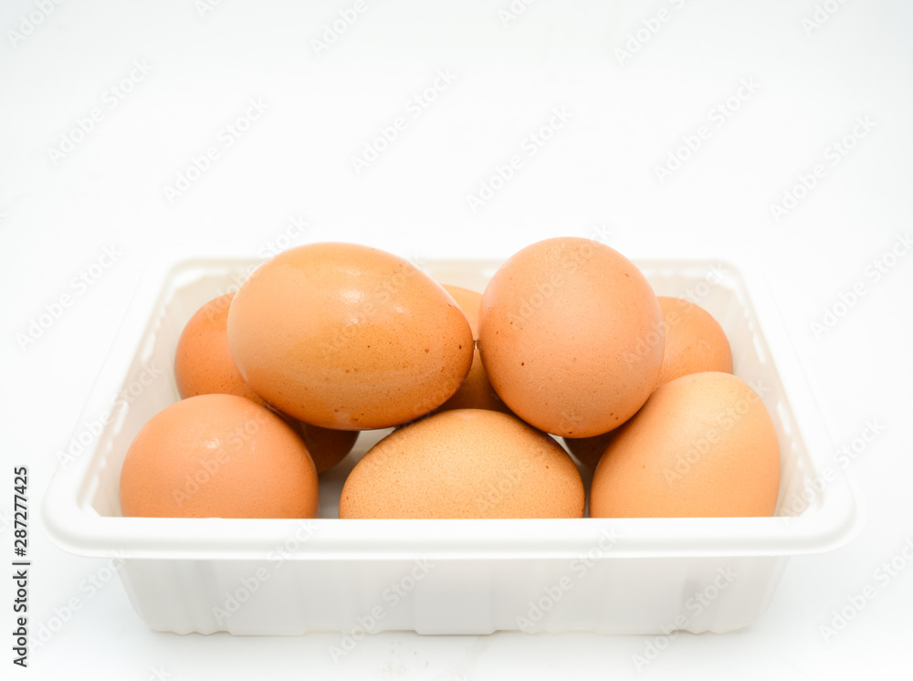 Eggs, fresh brown eggs in the white plastic box Eggs, fresh brown eggs in the white plastic box