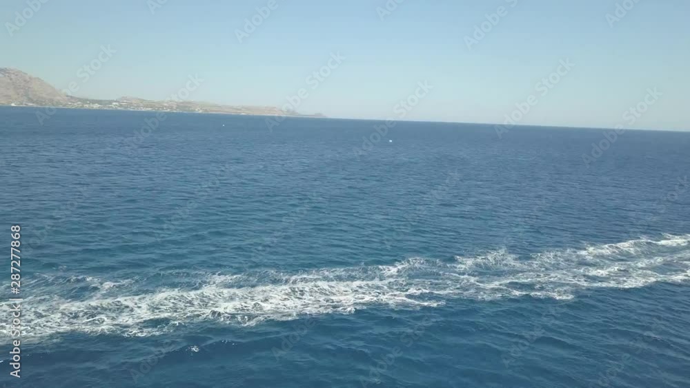Aerial drone shot of a man driving jet ski in azure water.drone makes a sudden movement away from jet ski Aerial drone shot of a man driving jet ski in azure water.drone makes a sudden movement away from jet ski