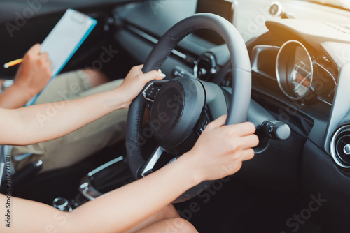 Obraz na plátně Woman practice driving car exam driver licence control steering wheel education
