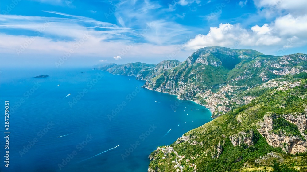 Panorama of the beautiful Amalfi Coast in Italy during summer, with vibrant blue water and sky, taken from the Path of the Gods hiking trail.