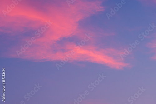 Blue and pink cloudy sky background.