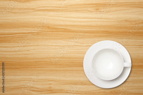 Top view of empty white coffee cup on a wood background. Template for your design.