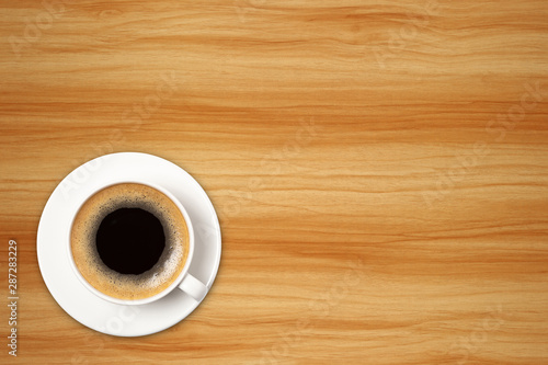 Top view of coffee cup on a wood background. Template for your design.