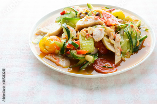 Cucumber salad with preserved pork sausages, Thai popular food called Som Tum Tang, Hot and spicy, mixed vegetables.