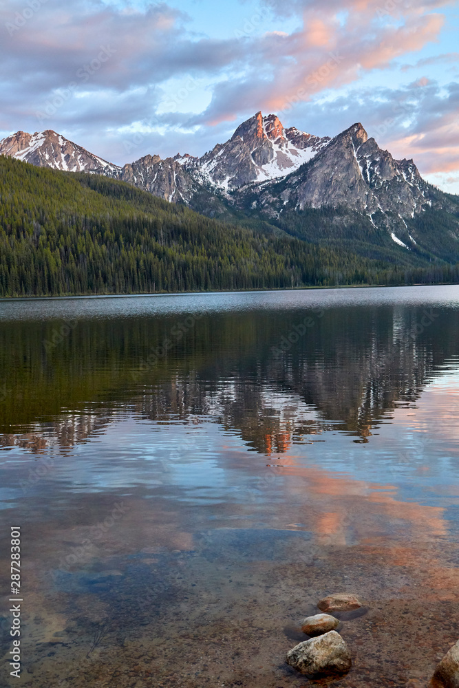 A glacier lake reflecting the Sawtooth Mts in the crystal clear water in Idaho