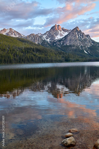 A glacier lake reflecting the Sawtooth Mts in the crystal clear water in Idaho