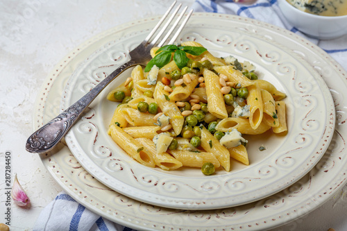Italian pasta with green peas and blue cheese.