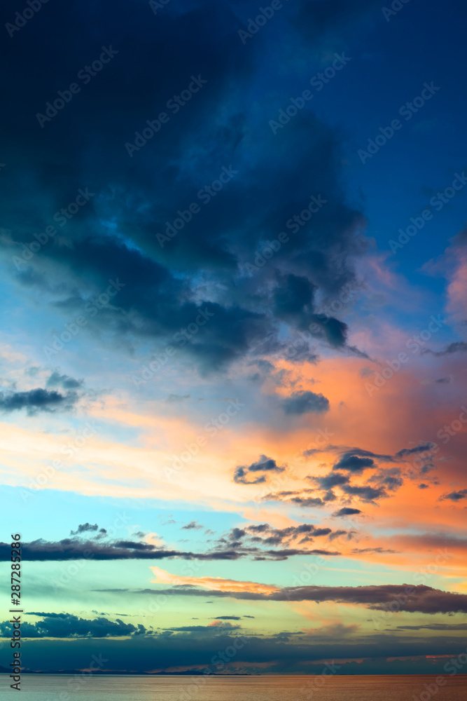 Evening sky with colorfully lit clouds shortly after sunset over Lake Titicaca viewed from the small tourist town of Copacabana in Bolivia