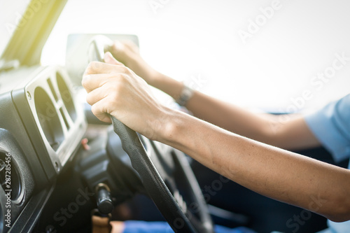 Man holding car steering wheel close up.  Concept of safe driving and automobile care. © DG PhotoStock