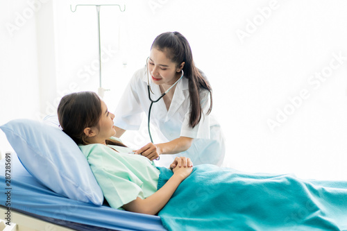 Doctor and her patient are discussing together in the room in hospital. Health care and medical services in modern lifestyle.