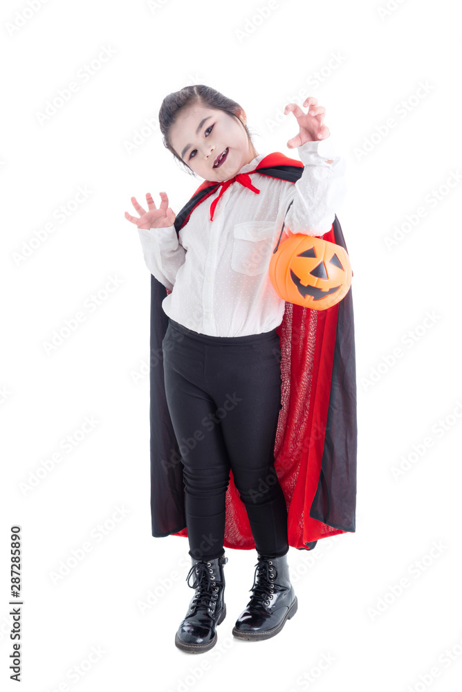 Full length of asian girl in vampire costume holding halloween pumpkin bucket and smiles over white background