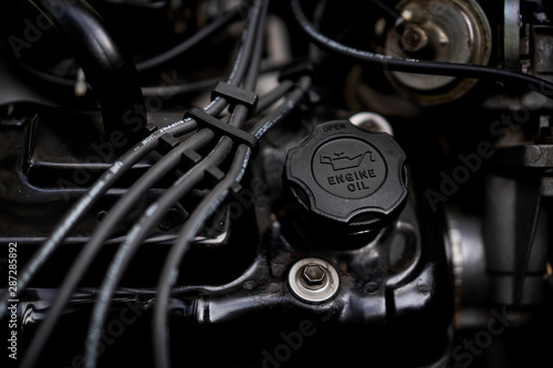 Engine oil cap on a vehicle engine close up.  Concept of saft driving and car maintenance. © DG PhotoStock