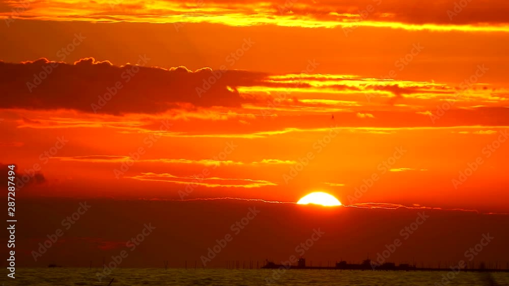 red flame sunrise on orange sky and dark red cloud on sea red flame sunrise on orange sky and dark red cloud on sea