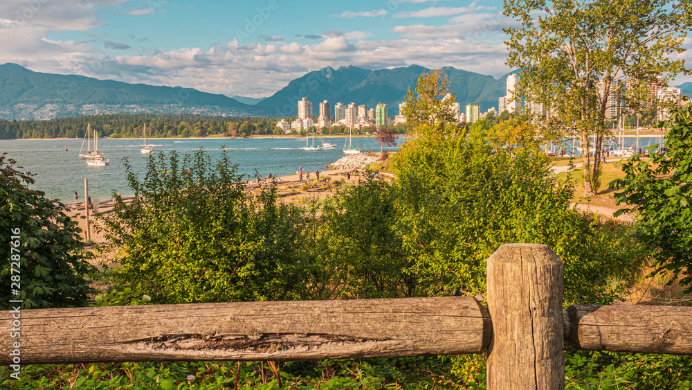 Driftwood-strewn Beach at Kitsilano Looking Across Bay to Stanley Park and North Shore Mountains