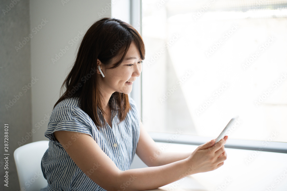 Young woman talking on smart phone with wireless head set Young woman talking on smart phone with wireless head set