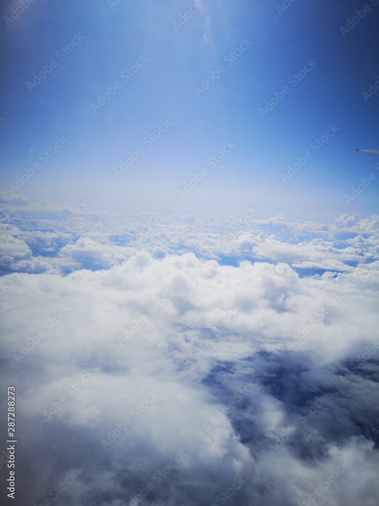 Fototapeta premium Cotton clouds from the plane's eiumator