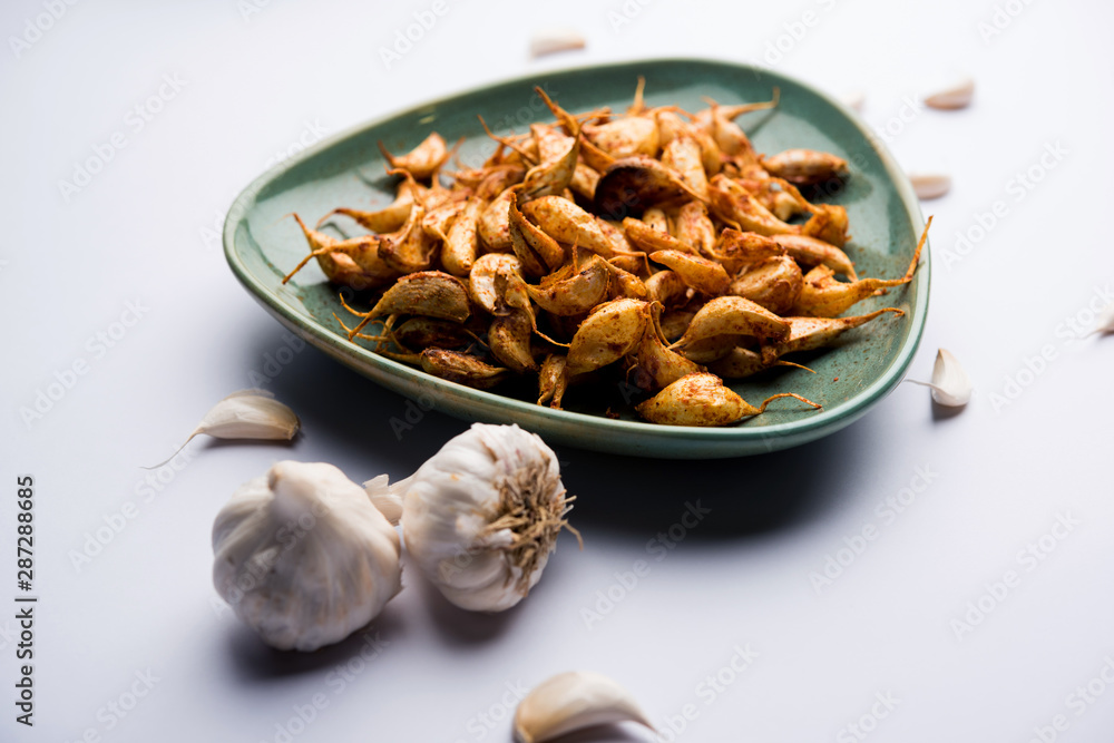 Garlic Fry or Tala Hua Lahsun in hindi, is a popular side dish or snacks from maharashtra, India Garlic Fry or Tala Hua Lahsun in hindi, is a popular side dish or snacks from maharashtra, India