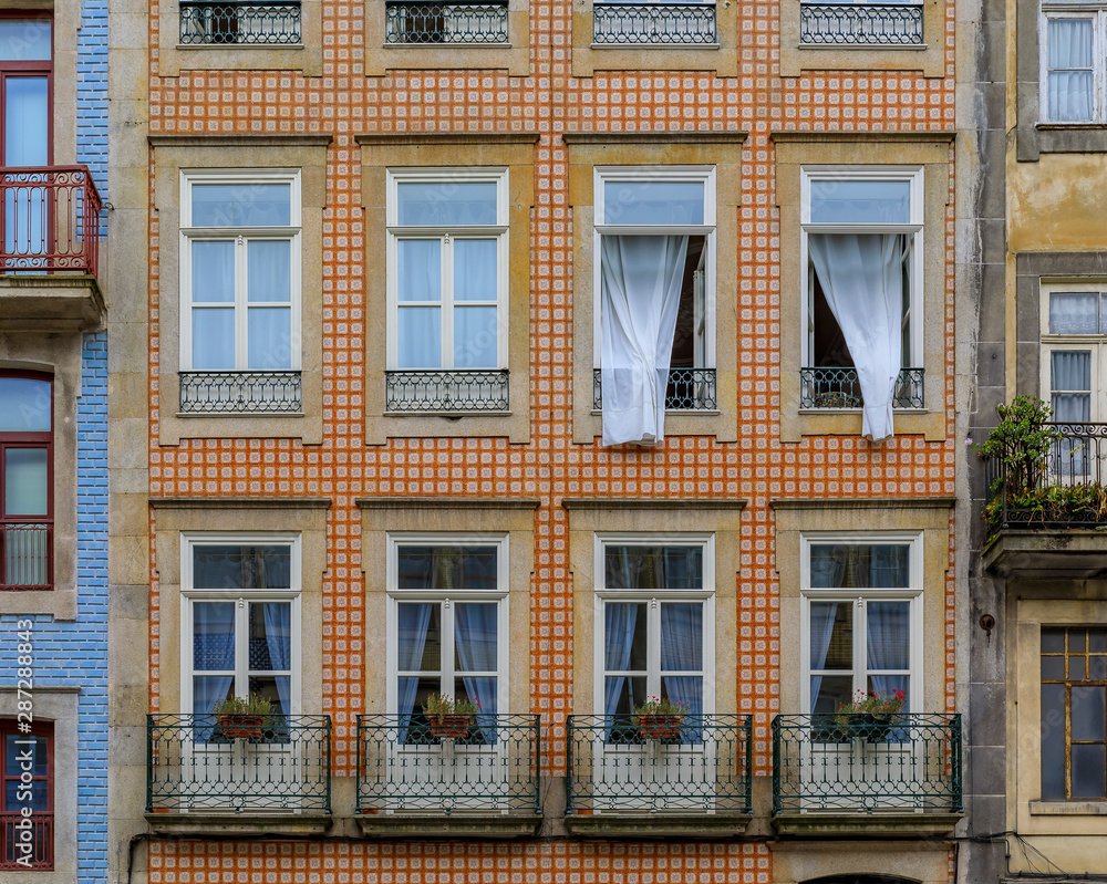 Fototapeta premium Facades of traditional houses decorated with ornate Portuguese azulejo tiles in Porto, Portugal
