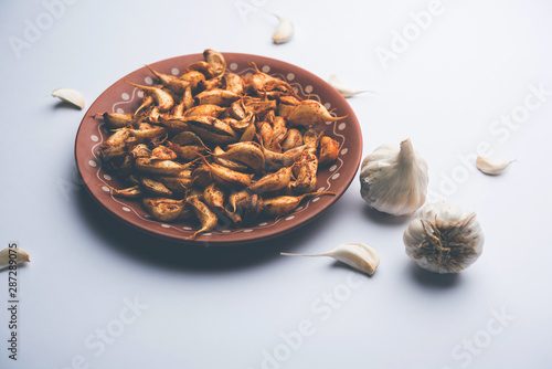 Garlic Fry or Tala Hua Lahsun in hindi, is a popular side dish or snacks from maharashtra, India photo