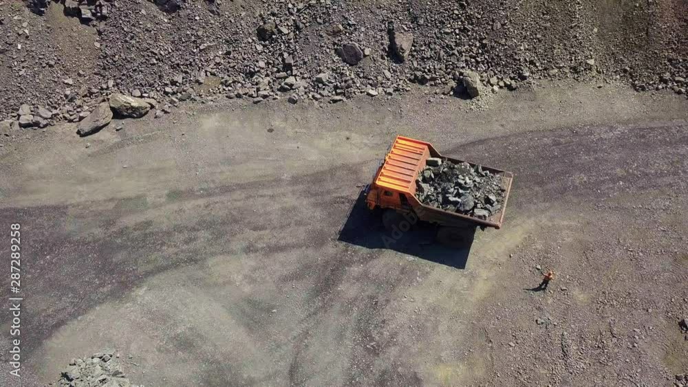 Aerial view A mining truck unloading iron ore. Aerial view A mining truck unloading iron ore.