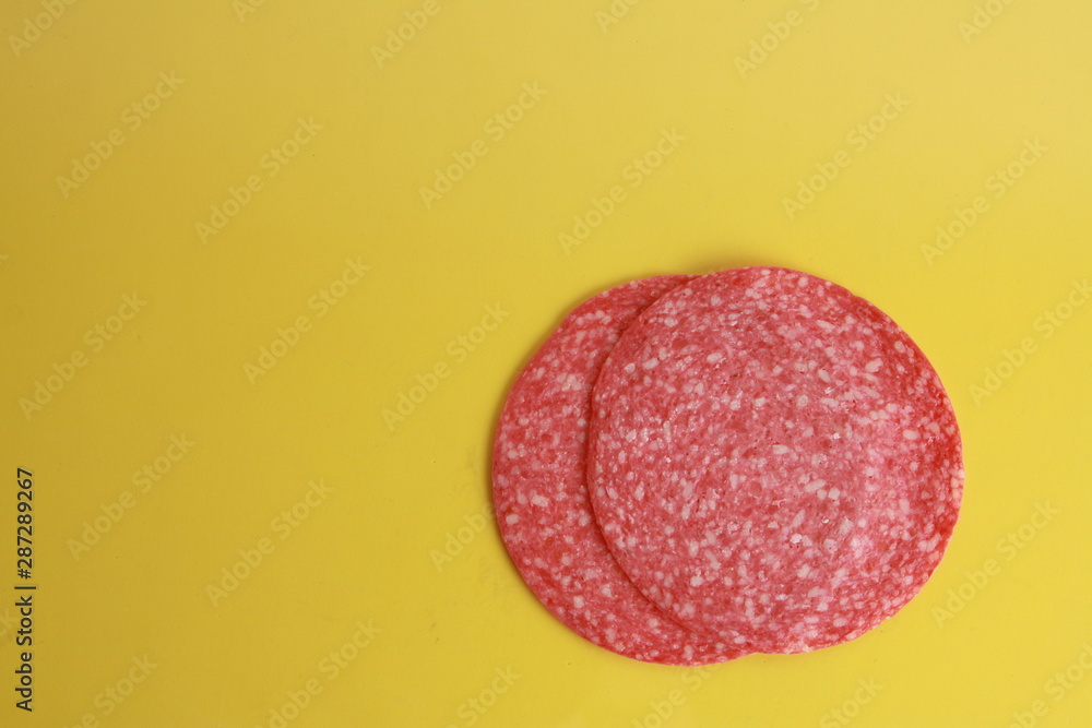slices of salami in colorful background slices of salami in colorful background
